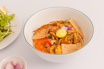 Mi Quang, Vietnamese rice noodles with meat, chicken stock, shrimp, egg, Vietnamese food isolated on white background, close-up