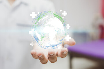 Medicine doctor holding earth hologram with health care symbol on virtual screen interface, modern virtual screen interface, medical technology and and futuristic concept.
