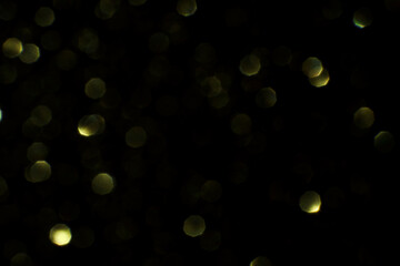 Bokeh circle with gold sparkles background. Yellow glitter backdrop. Monochrome texture. New year luxury snow. Copyspace. Shimmer confetti wallpaper. Dreamy shiny design detail. For multiply