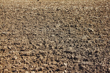 New plowed soil. The background texture of the soil of agricultural land. Agriculture, preparation for spring sowing.