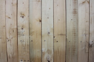 Fototapeta premium A new wooden fence with knots of natural color.