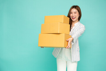 Asian businesswoman holding package parcel box isolated on green background, Delivery courier and shipping service concept