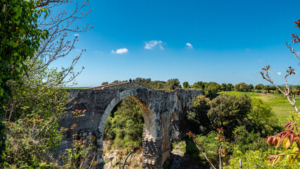 Fototapeta na wymiar Ancient Ponte dell'Abbadia known as the Devil's Bridge in Vulci, Lazio, Italy
