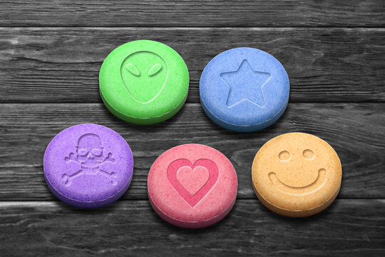 MDMA Or Ecstasy Pills On Dark Wooden Background