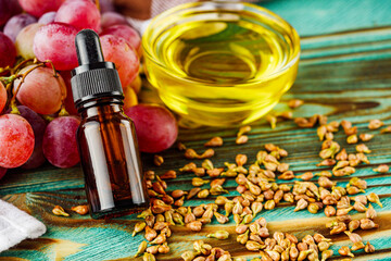 grape seed essential oil on a wooden rustic background