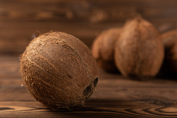 Coconut on brown texture wood. exotic fruit