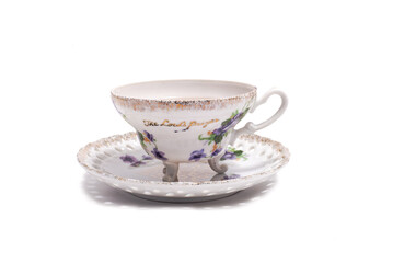 vintage tea cup with legs and an openwork saucer on a white background
