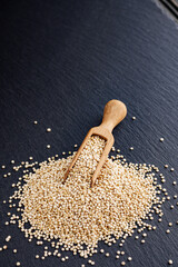white quinoa seeds on a dark rustic background