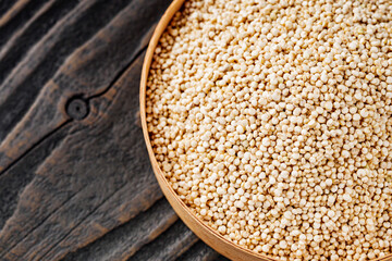 white quinoa seeds on a dark rustic background