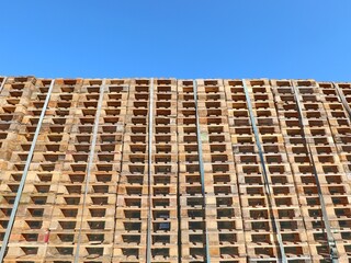 many wooden pallets and blue sky