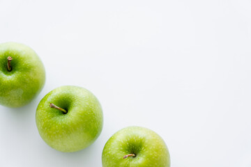 high angle view of tasty whole apples on white.