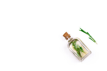Fototapeta premium Aromatherapy herbal oil. Bottle glass with rosemary essential oil and fresh rosemary twig on white background.
