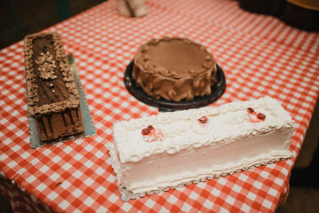  Luxury chocolate cake frosted with whipped cream and covered with chocolate shavings on cake stand.