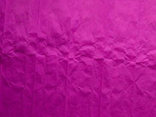Crumpled colored paper, paper background, pattern. The texture of crumpled purple corrugated paper