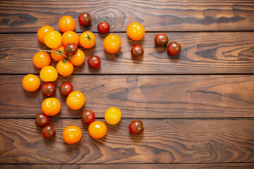 Fototapeta na wymiar various tomatoes on dark wooden table