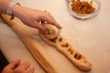 A baker prepares a braid of dough for baking into a special round challah bread for Rosh Hashana, the Jewish New Year. Fruit is added to symbolize the desire for sweetness in the coming year.