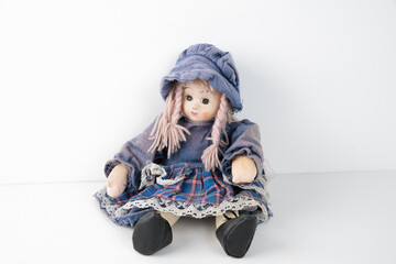 Old vintage rag doll in a dress.