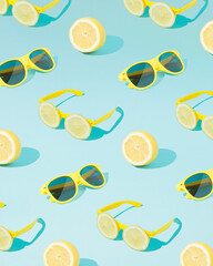 Creative summer pattern made of sunglasses and lemon on a blue background. Minimal concept.