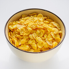 crispy golden cornflakes on a white acrylic background