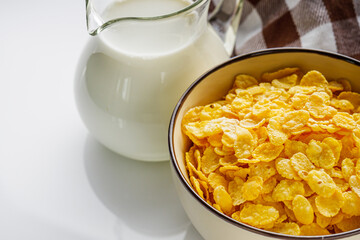 crispy golden cornflakes on a white acrylic background