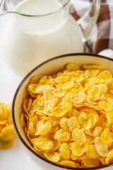 crispy golden cornflakes on a white acrylic background