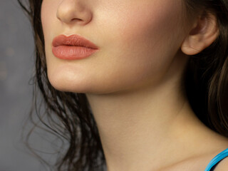 Fototapeta premium Close-up of woman's Lips with Fashion pink Make-up and Manicure on Nails. Beautiful female full lips with perfect Makeup. Part of female face. Macro shot of beautiful make up on full lips