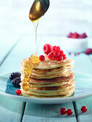 Pancake with berries and syrup