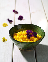 Risotto cooked with saffron and edible flowers