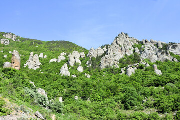 Fototapeta na wymiar Landscape with big stones of the Valley of Ghosts on Demerdji mountain, Crimea, Russia. It is a natural landmark of Crimea. Scenic view of the bizarre rocks in Southern coast of Crimea