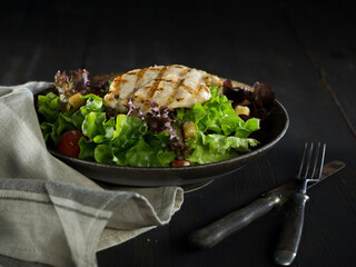 Grilled chicken salad on rustic background