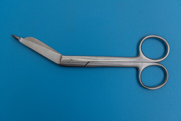 Bandage scissors on blu background.