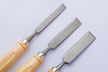 Chisel and shavings isolated on white background. Carving hand tools or chisels on a white...