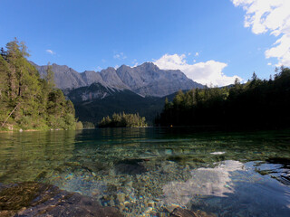 Naklejka na ściany i meble Beautiful nature of Germany's Eibsee, turquoise water lake with stunning view on the Alps