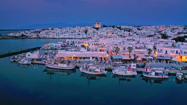 Greece island Paros tavernas and boats in harbor bay aerial evening view