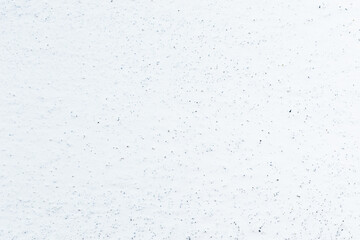 Plaster on a gray wall covered with chalk. The texture of the whitewashed plaster is close-up.
