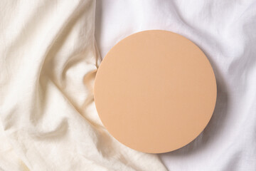 Blank pastel round platform podium for cosmetics or products on natural white linen fabric...