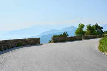 A sharp turn on a serpentine. Mountain road on overlooking a beautiful mountain landscape. Montenegro.