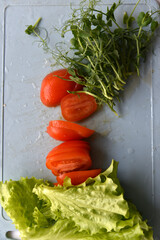 Salad on a cutting board tomatoes greens and peas