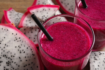 Delicious pitahaya smoothie and fresh fruits on table, closeup