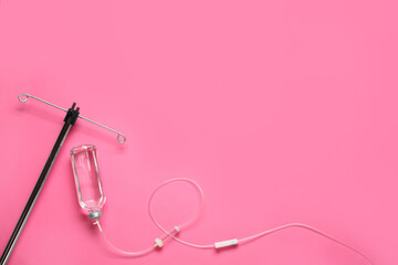 IV infusion set on pink background, flat lay. Space for text