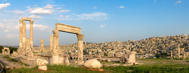 Amman, Jordan its Roman ruins in the middle of the ancient citadel park in the city center. Sunset over Amman skyline and historic city center with beautiful views of the historic capital of Jordan.