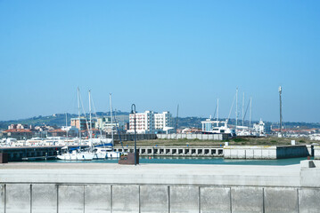 Fototapeta premium Beautiful view of city from pier with boats