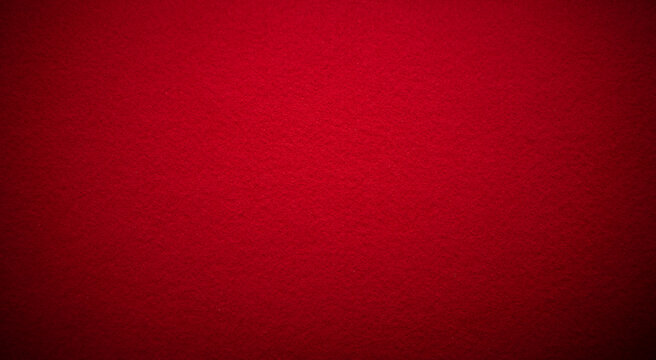 Photo of a fabric texture of crimson red color . The background is dark red with a black vignette. The texture of the felt fabric for the inscription.