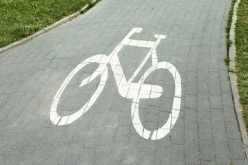 Fototapeta na wymiar Bicycle lane with white sign painted on asphalt, above view