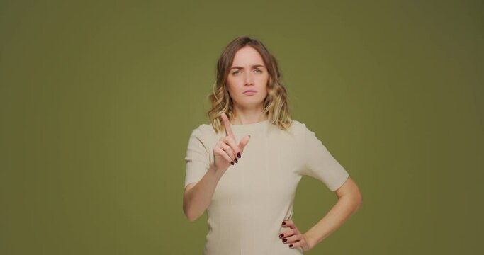 Serious angry emotional woman wag finger, scolding, reprimanding, warning, prohibiting by raised forefinger