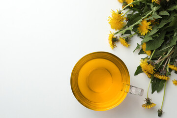 Delicious fresh tea and beautiful dandelion flowers on white background, flat lay. Space for text