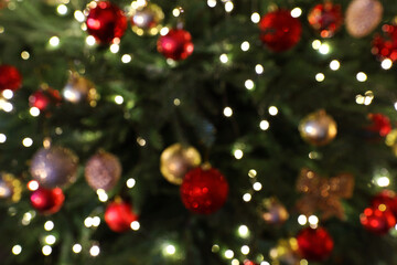 Obraz na płótnie Canvas Blurred view of beautifully decorated Christmas tree, closeup
