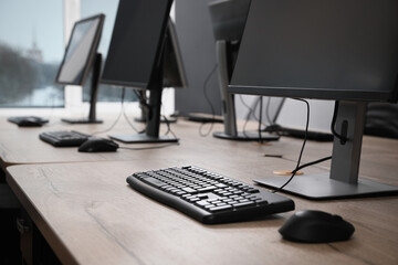 Many modern computers in open space office, closeup view - obrazy, fototapety, plakaty