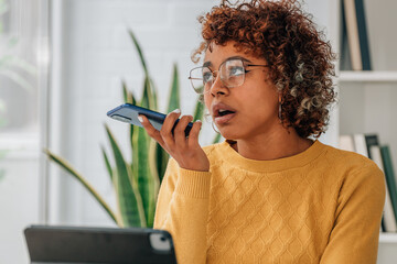 african american girl with mobile phone sending voice message