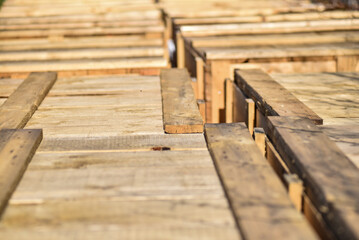 Wooden boxes from planks stacked in a row